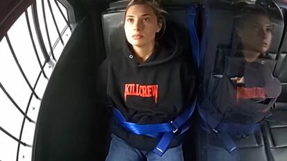 Christina Formella sitting in the back of a squad car