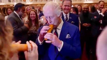 King Charles playing a carrot in a crowd