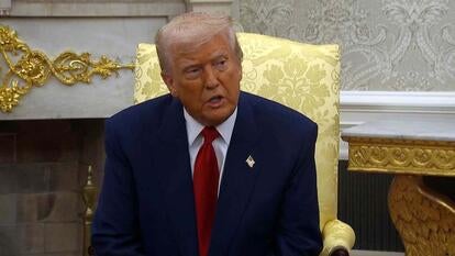 President Donald Trump sitting in Oval Office speaking to reporters