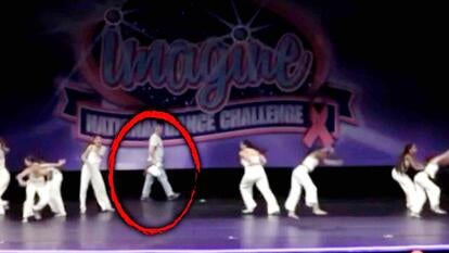 Group of young dancers with a person circled holding a pizza