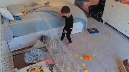 Little girl crawling under crib while brother watches