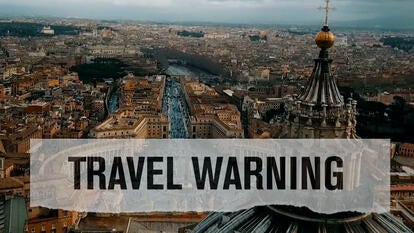 An overhead view of Vatican City, with the words "TRAVEL WARNING"