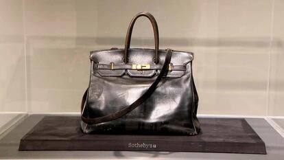 Birkin bag inside of a glass display case