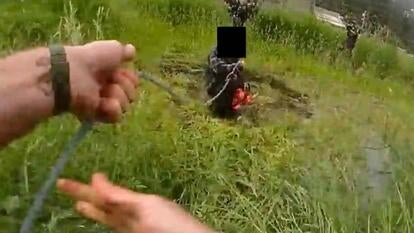 Lasso thrown over man holding chainsaw