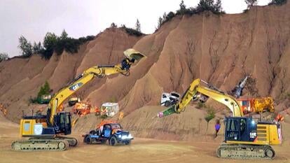 Two excavator machines and a pickup truck