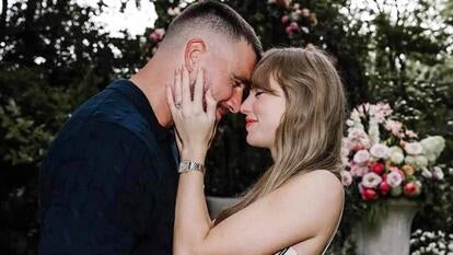 Taylor Swift and Travis Kelce smiling together showing engagement ring