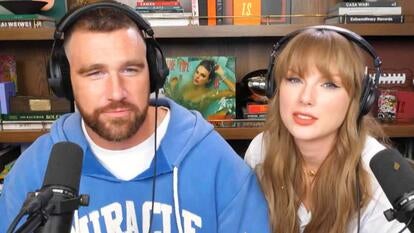 Travis Kelce and Taylor Swift wearing headphones and speaking into microphones for a podcast