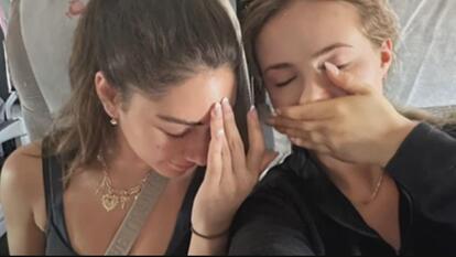 Two women next to each other, hands on their faces