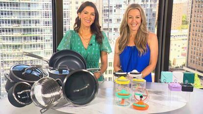 Two women standing behind a table displaying Cookware Set, Food Choppers, Photo Printer