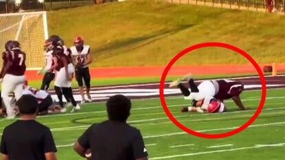 Red circle over a football playing belly flopping onto a player on the opposing team