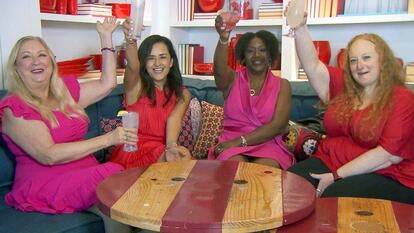 4 women raising a glass to cheers