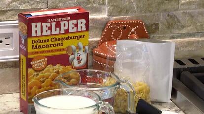 Kitchen countertop with box of 'Hamberger Helper' and other ingredients 