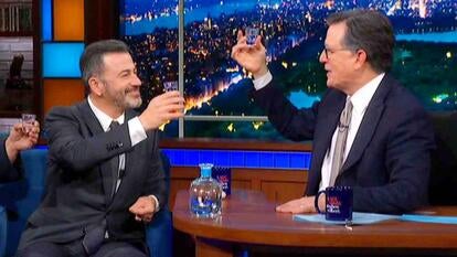 Jimmy Kimmel And Stephen Colbert cheers with small glasses