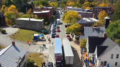 Vermont road through a small town with traffic in both directions