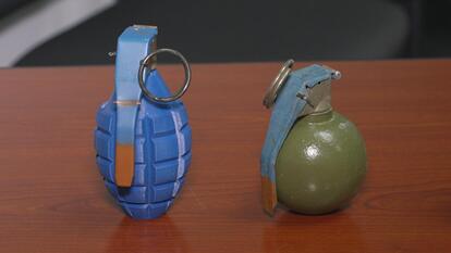 Two hand grenades sitting on a table