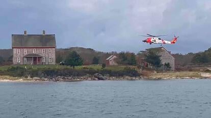 Medical helicopter flying over cottage on an island
