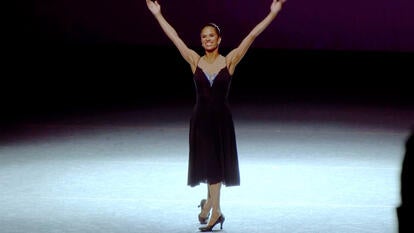 Misty Copeland with arms raised on stage