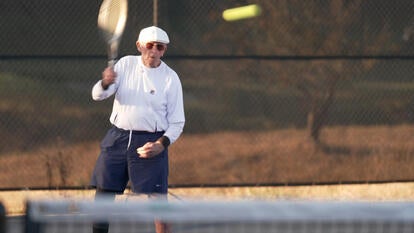 Man swinging a tennis racket