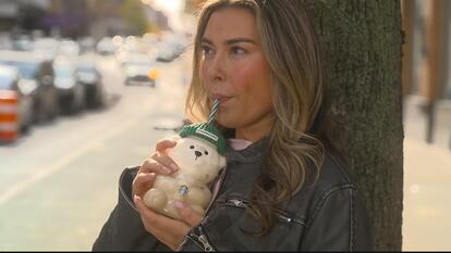Woman drinking out of a Starbucks bear cup