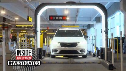 SUV in a parking garage driving through a lit-up arch