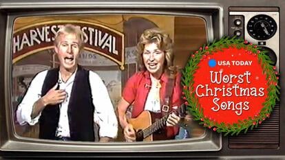 A man and a woman singing and playing guitar / holiday wreath that reads 'Worst Christmas Songs'