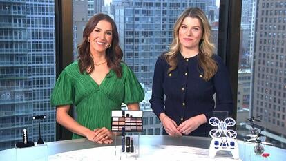 Two women standing behind a table displaying a Jewelry Set, Drone, Makeup Set