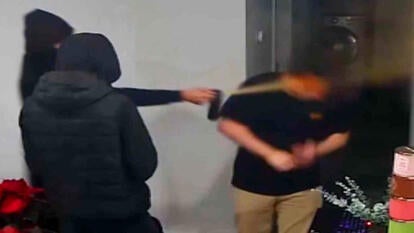 Jason Nguyen being bear sprayed in the face by two men dressed in all black