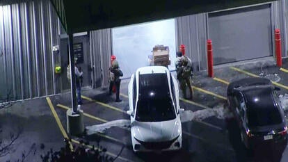 Drone view of officers standing outside of a storage unit