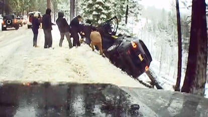 Human chain reaching into ravine