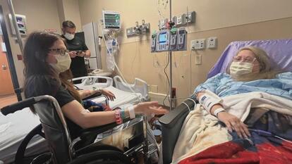 Woman in hospital bed, another woman in wheelchair next to her