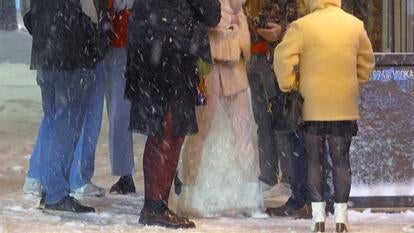 Group of young adults standing together in the snow