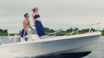 A scene from 'Love Story' where actors portray JFK Jr & Carolyn Bessette on a boat