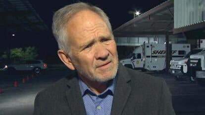 Ed Smart speaking to an interviewer outside at night