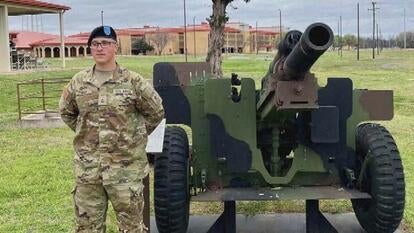 Sgt. Declan Coady standing next to cannon