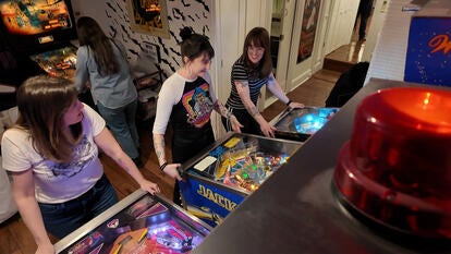 Women playing pinball