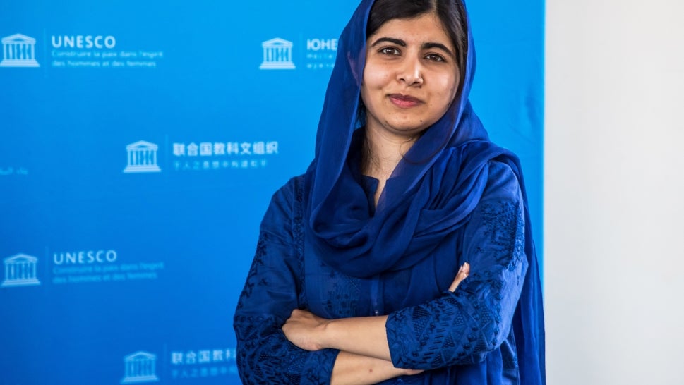 Malala Yousafzai standing for photo in blue outfit