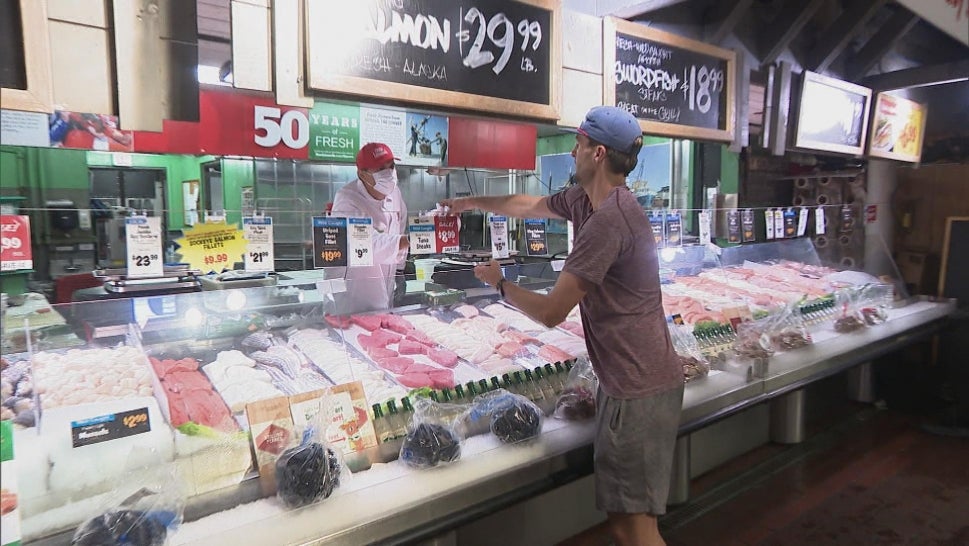 Man buying lobster at a grocery store