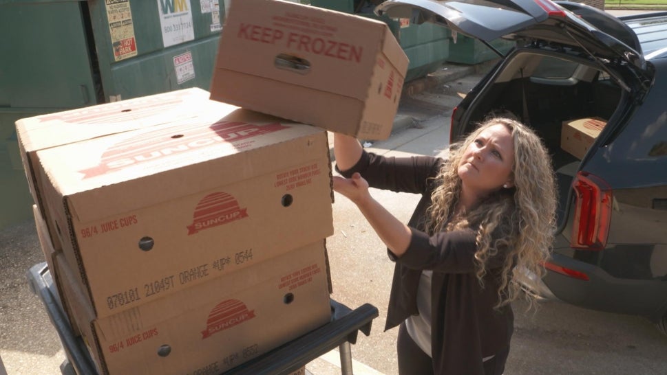 A woman loading frozen food into her car