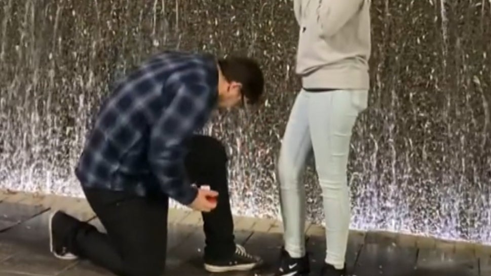 Man Proposing Drops Ring Into Fountain