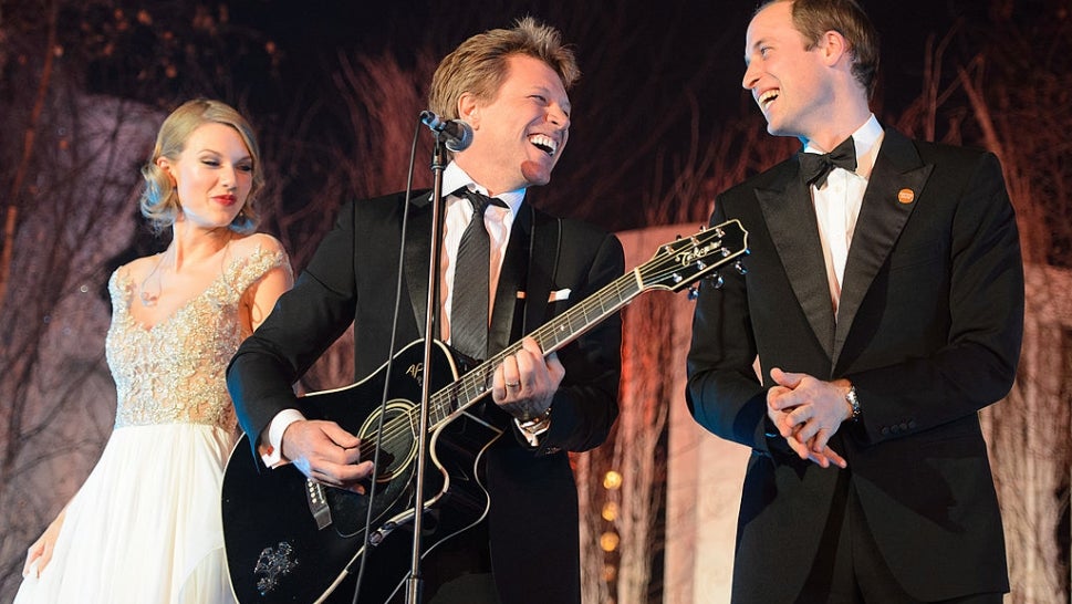 Taylor Swift, Bon Jovi holding a guitar, and Prince William - all on stage smiling