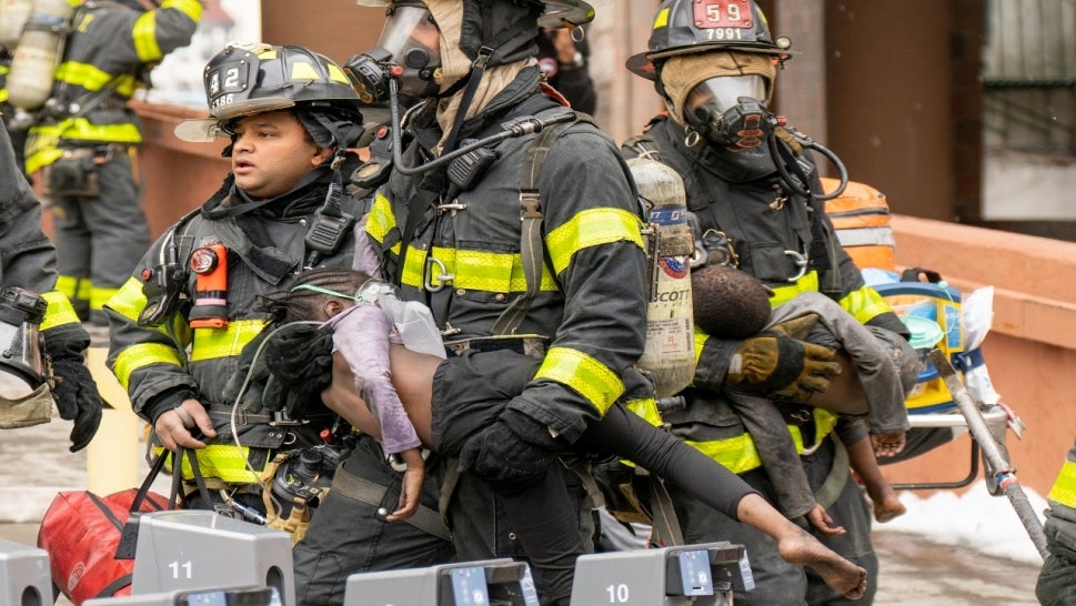 New York firefighters carried out child victims from Bronx fire.