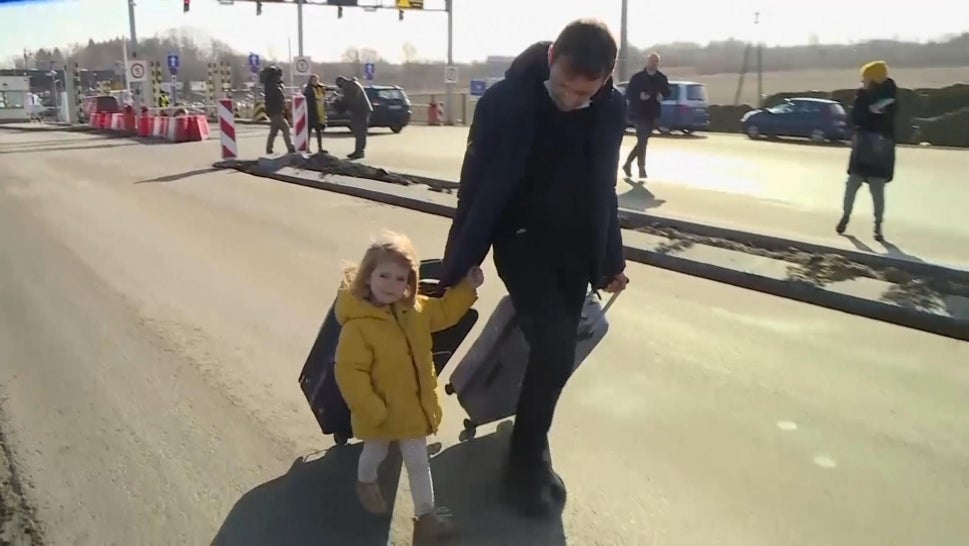 Ukrainian Family Walks Across Polish Border to Escape Attack