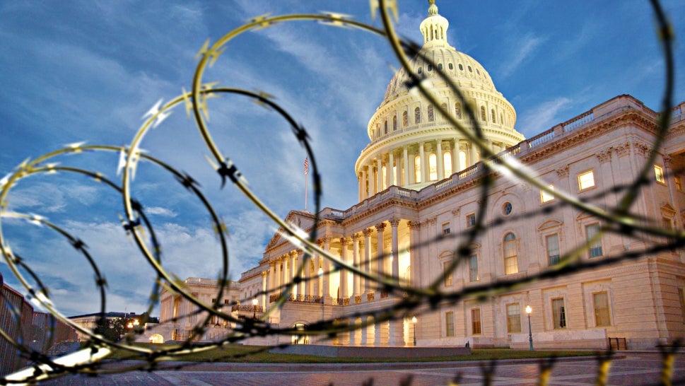 View of capitol behind barbed wire