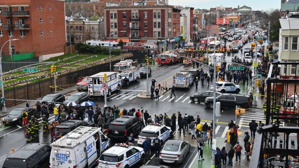 Emergency vehicles and the New York Police Department crowd the streets after at least 13 people were injured during a rush-hour shooting at a subway station in the New York borough of Brooklyn on April 12, where authorities said "several undetonated devices" were recovered amid chaotic scenes.
