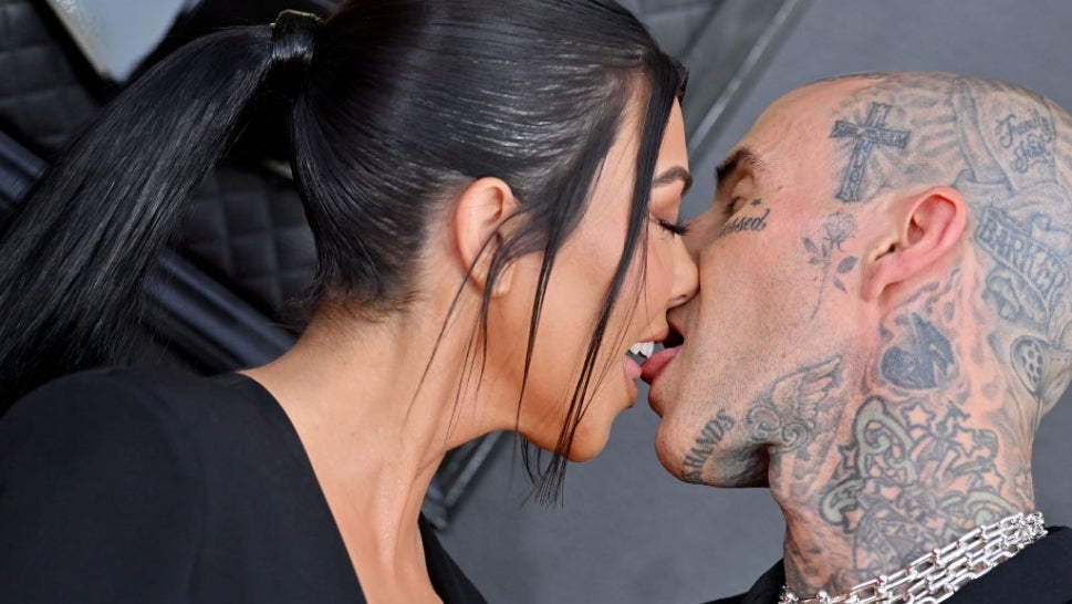Kourtney Kardashian and Travis Barker made headlines Sunday for their steamy red carpet kiss.
