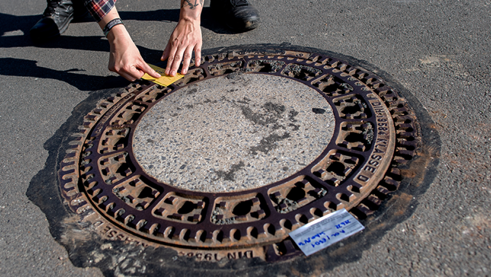 Image of manhole being sealed shut