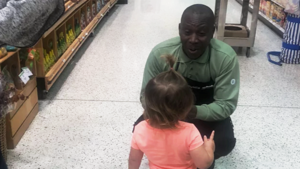 Publix worker excitedly talking to toddler