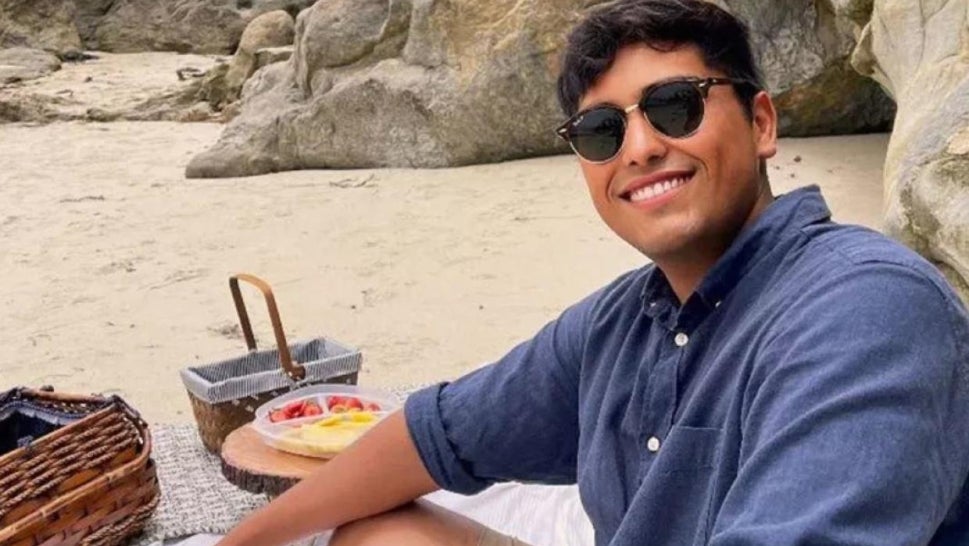 Misael Sanchez, smiling at beach picnic