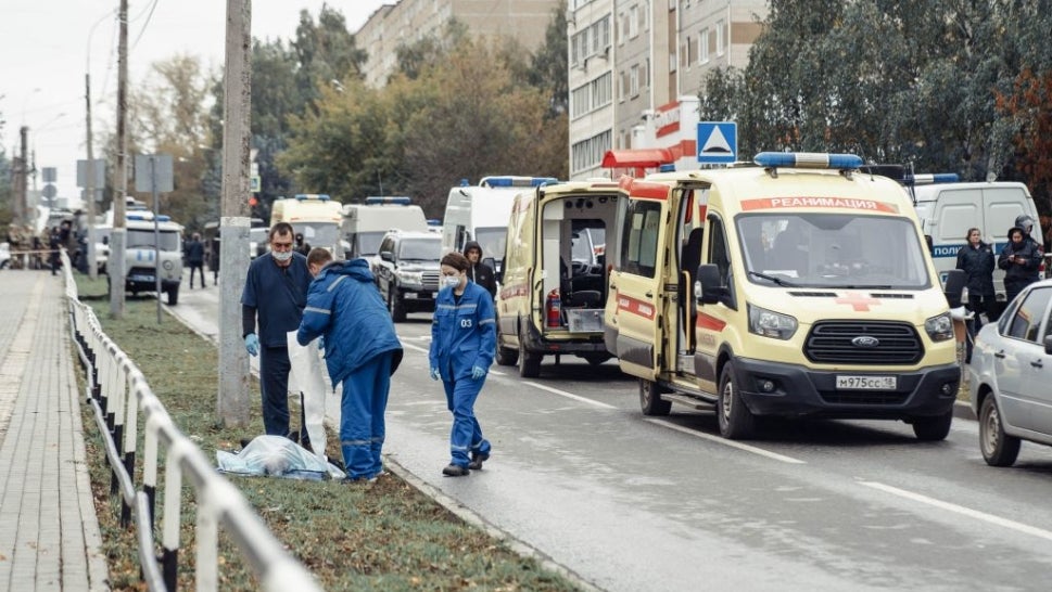Medics gather at the body of a dead person near the scene of a shooting in school No88 in Izhevsk