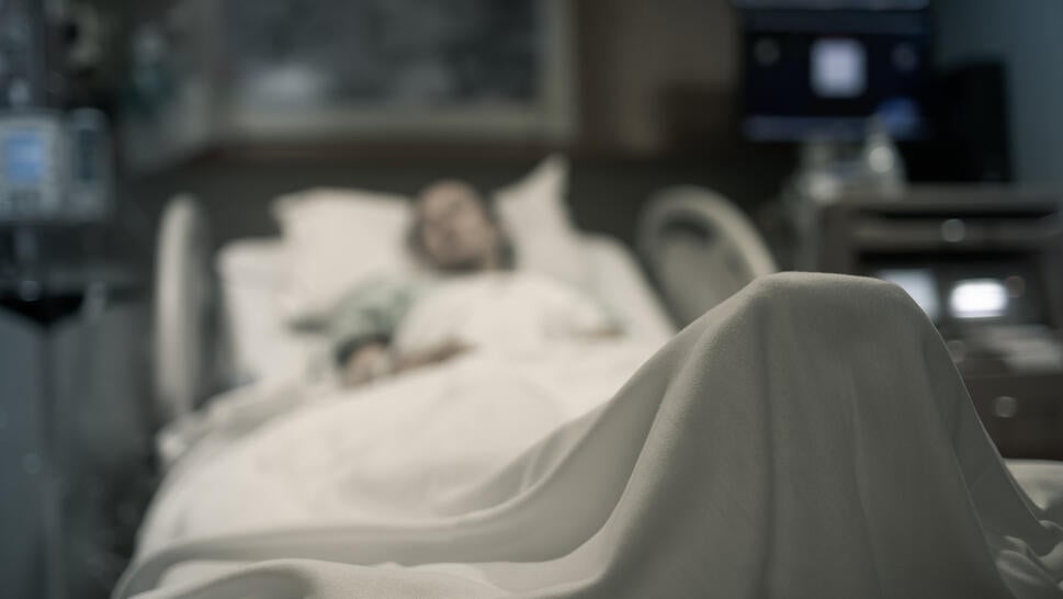 A stock image of a woman in a hospital bed.